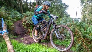 A mountain bike rides through some muddy ruts