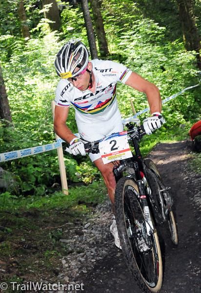 World champion Nino Schurter (Scott Swisspower) dismounting for some mud.