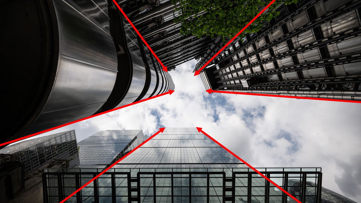 A look-up image of tall buildings in London with red arrows indicating leading lines 