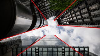 A look-up image of tall buildings in London with red arrows indicating leading lines 