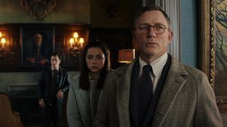 Daniel Craig standing in front of Ana de Armas in Knives Out