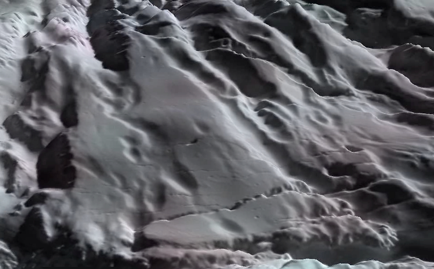 Perspective view of &quot;snow&quot;-covered slopes of Enceladus. This heavily fractured terrain lies north of the edge of the active south polar region.