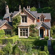 Exterior of a grand Regency house with ornate roof details and grand porch with columns
