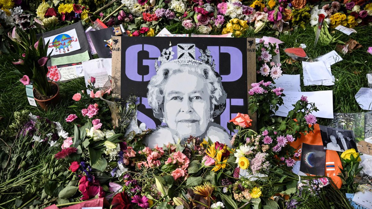 A picture of Queen Elizabeth II is seen among floral tributes left in Green Park