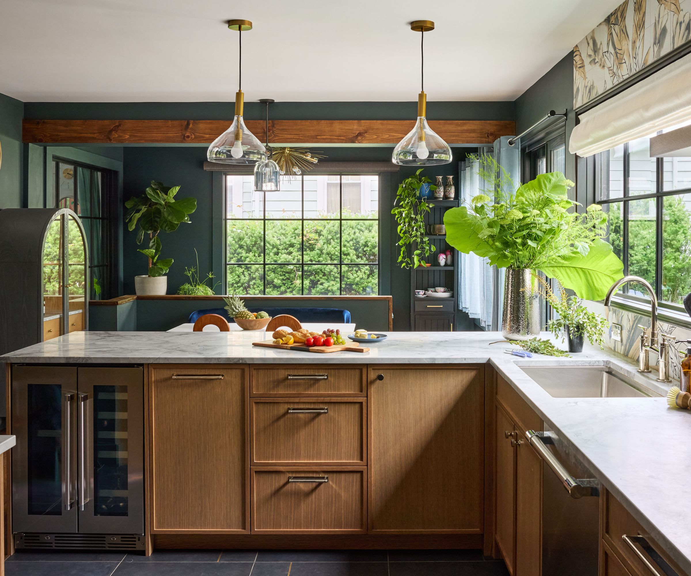 A wooden kitchen with dark painted walls