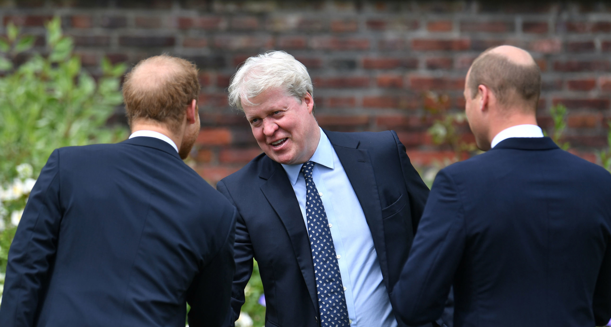 Earl Spencer shaking hands with Prince Harry and Prince William