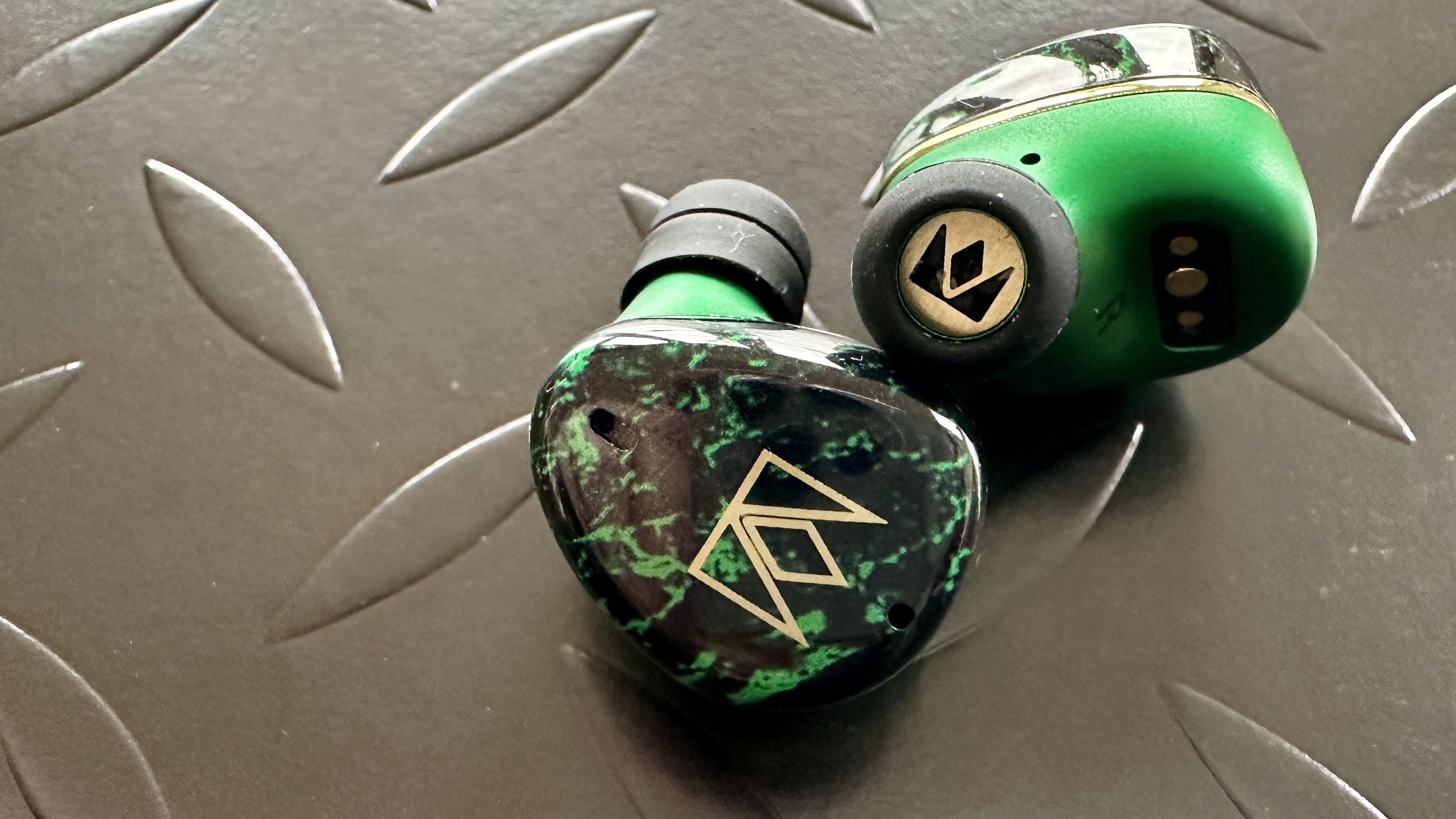 The ear-tips of the Noble FoKus Rex5 earbuds on a metallic surface