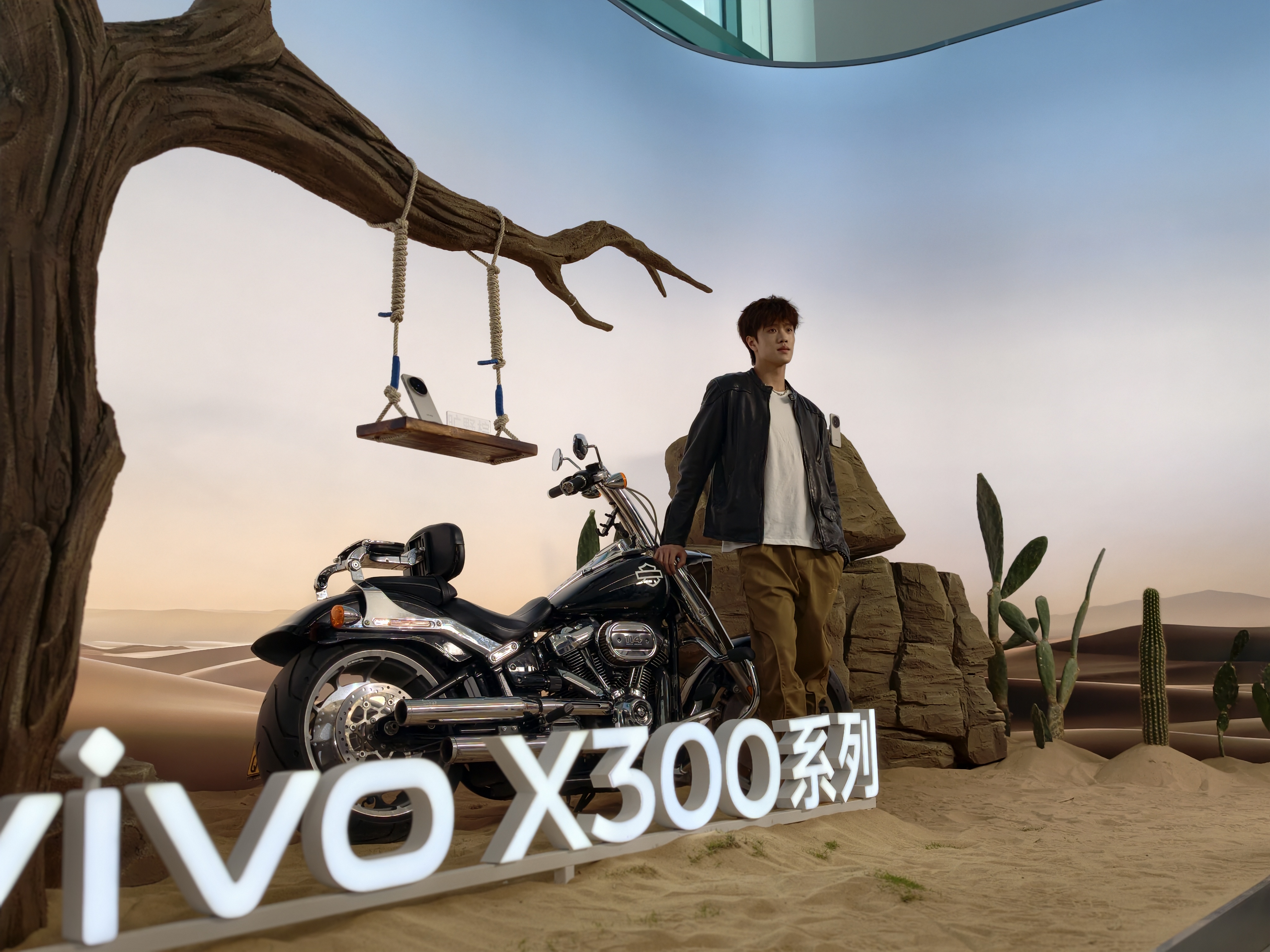 A model posing with a motorbike and a sign reading vivo x300