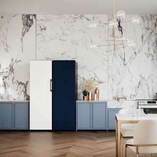 samsung bespoke refridgerator with one half dark blue the other white, in a kitchen with marble wall