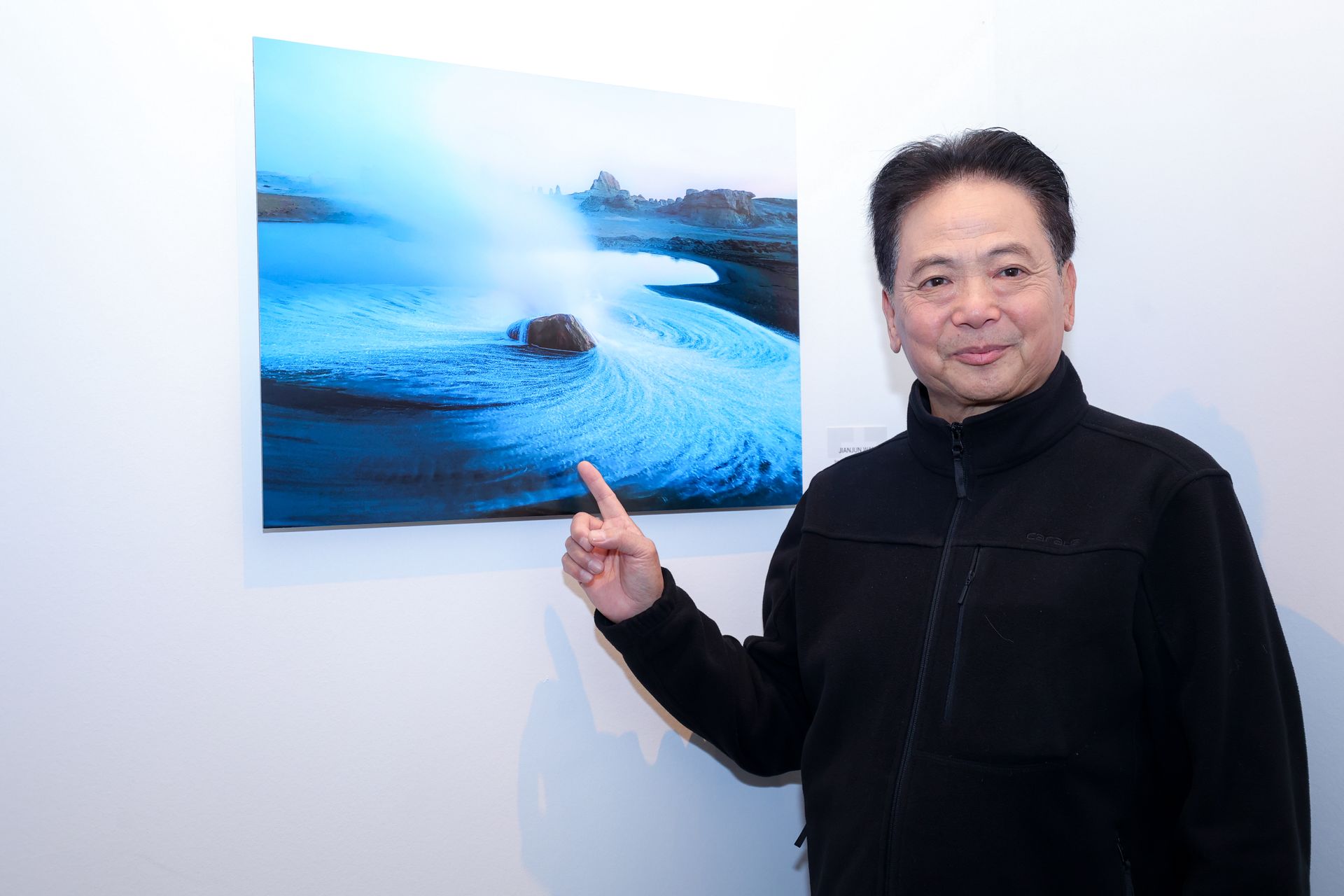 Photographer points to image at OPPO Paris Photo 2023