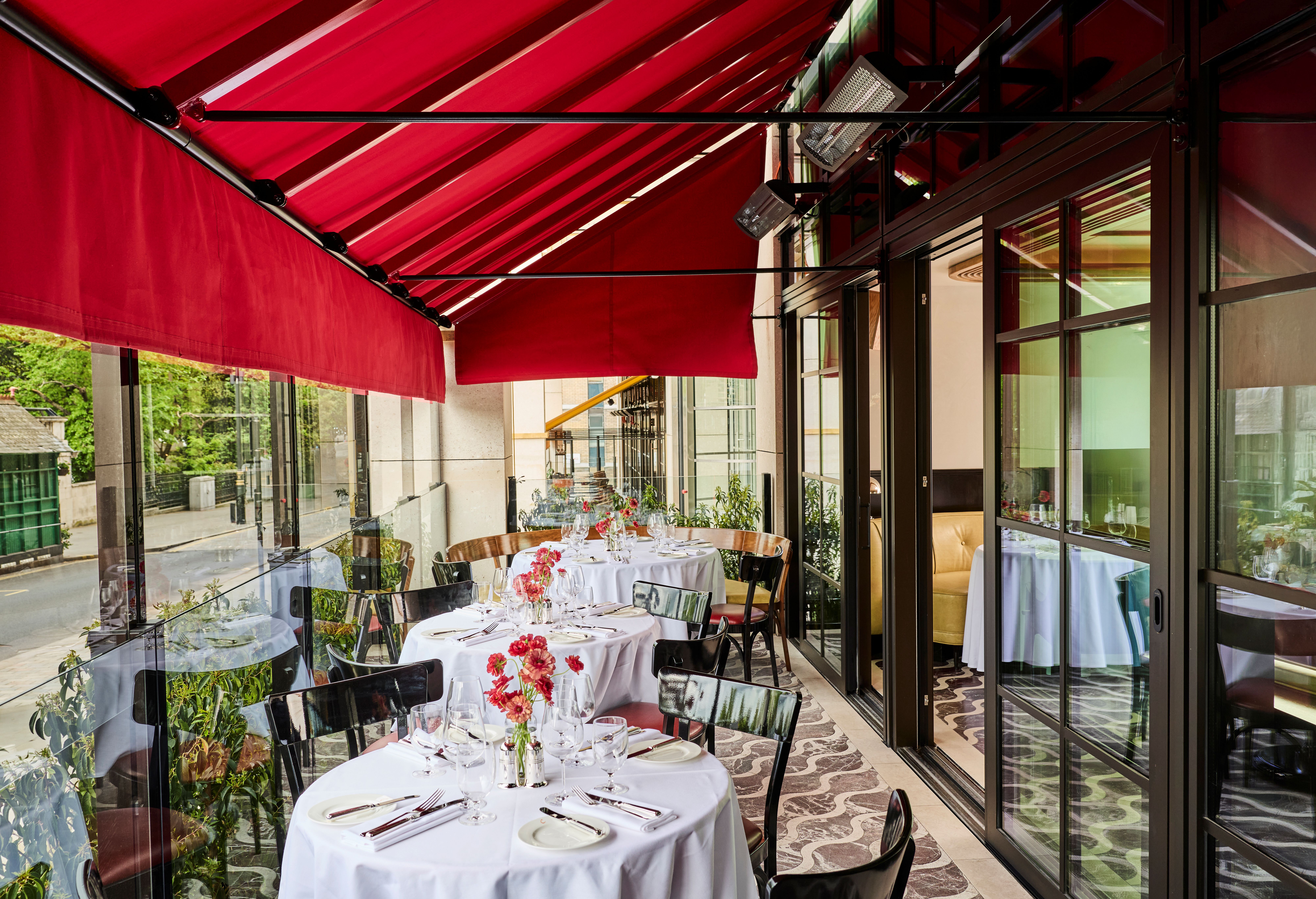 Brasserie-style dining room with warm tones, river views and an open, airy atmosphere