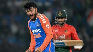 India's Riyan Parag celebrates after taking the wicket of Bangladesh's Mehidy Hasan Miraz (R)