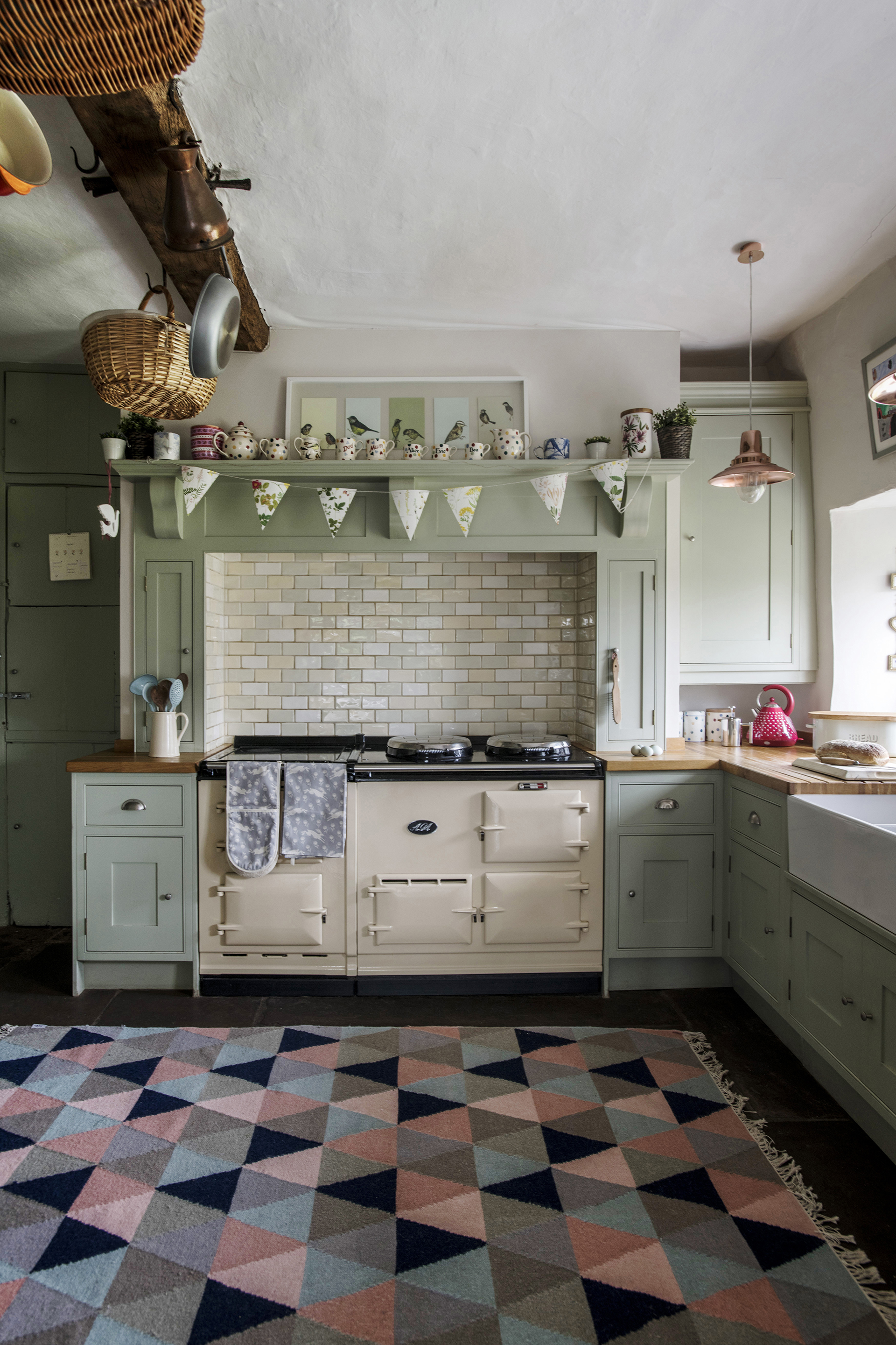 pantry filled with vintage tins and partly covered by a floral vintage curtain