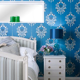 bedroom with floral printed blue wall