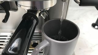 Breville Barista Express' hot water jet in a mug making Americano