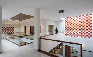 hero shot of the central circulation space with jaali screens at The Manjeri Residence in India