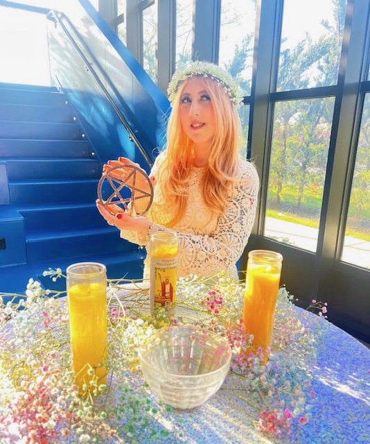 young woman with blonde hair performing a ritual