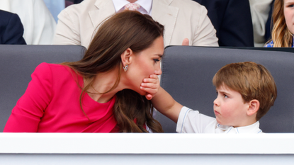 Prince Louis of Cambridge covers his mother Catherine, Duchess of Cambridge&#039;s mouth with his hand as they attend the Platinum Pageant on The Mall on June 5, 2022 in London, England.