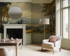 A living room with a landscape wallpaper