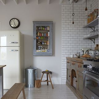 kitchen with white wall wooden cabinet white refrigerator blue wall shelve