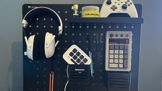 Black peg board with gaming accessories and gadgets