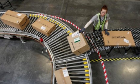 An Amazon employee sorts packages in Arizona: The online retailing giant's deep discounts may be its demise.
