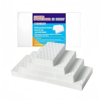 A stack of white magic erasers, in front of a blue packet. 