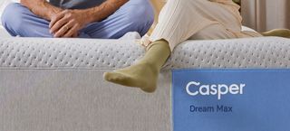 Close crop of a couple sitting on a Casper Dream Max Hybrid Mattress