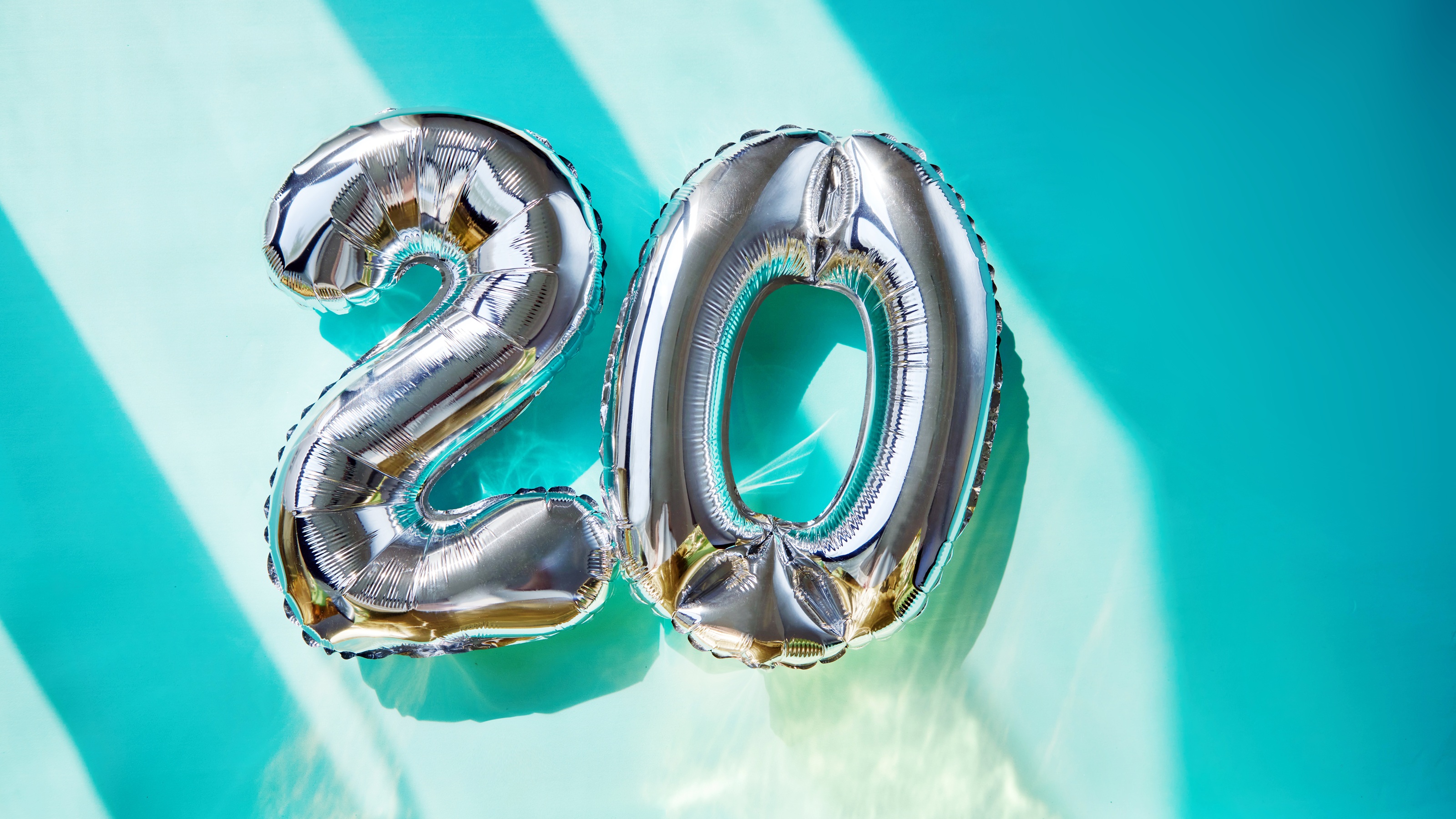 The number 20 rendered in puffy silver balloons.