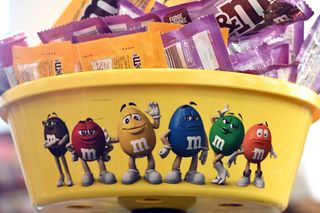View of the M&M's anthropomorphized candy characters that have gotten a redesigned look, stamped on a retail store purchase container, New York, NY, January 21, 2022. Brown M&M character has been designed with feminine high heels and Green M&M receiving boots.