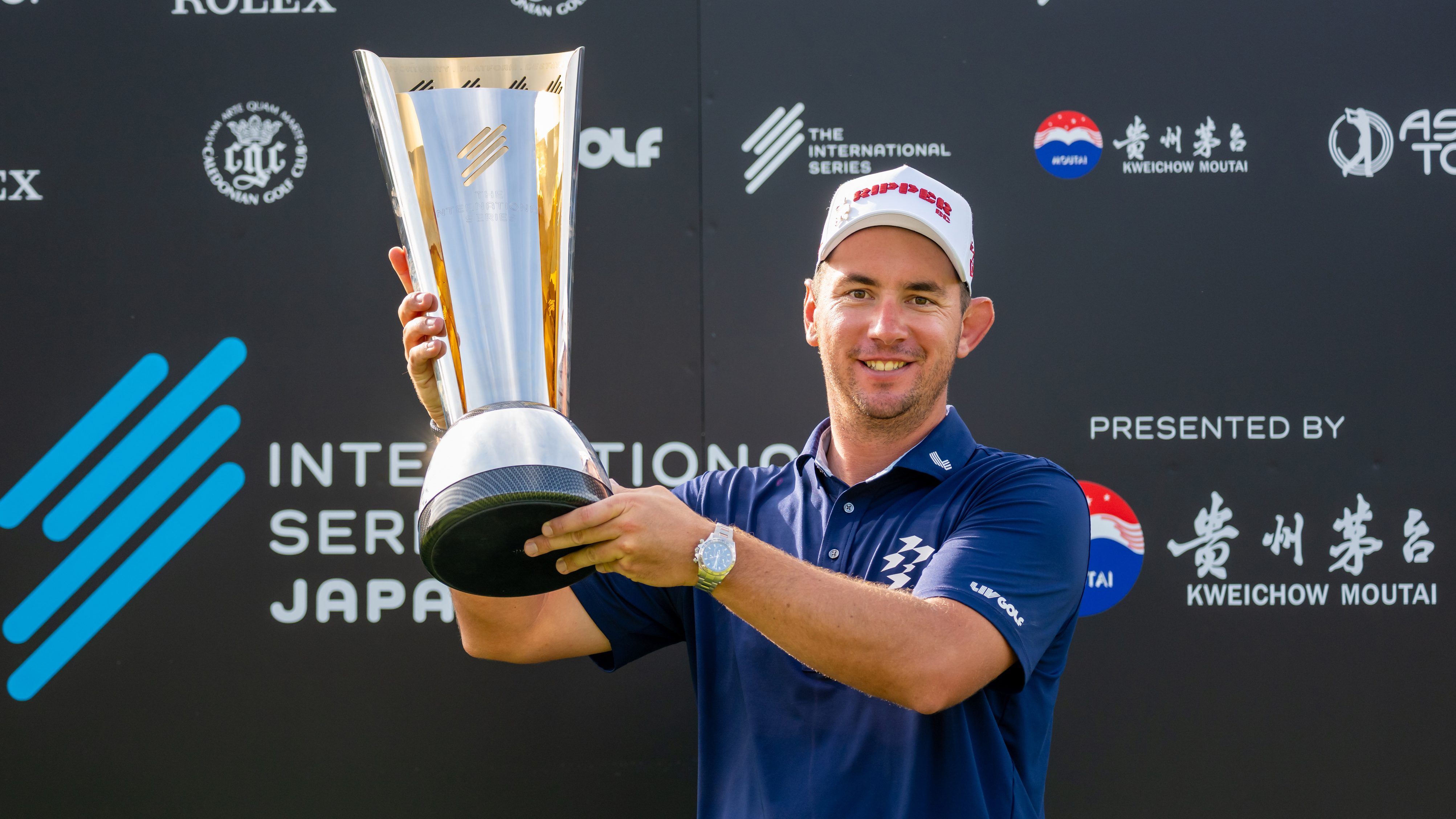 Lucas Herbert holds up the International Series Japan trophy after winning in 2025