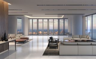 Inside of an apartment with beige seating area and view of the city from glass windows