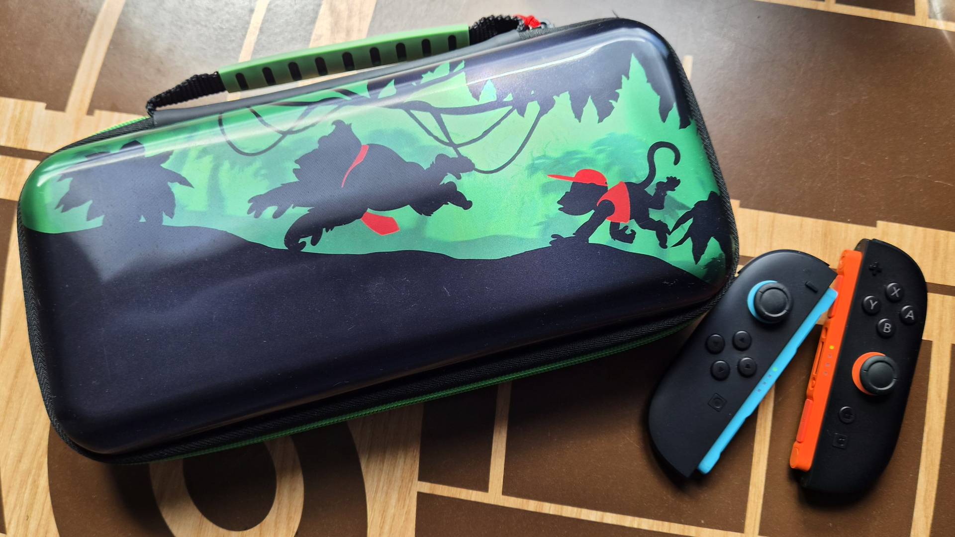 Photo of the Donkey Kong PlayTrek Switch 2 case with a pair of Switch 2 Joy-Con to its side.
