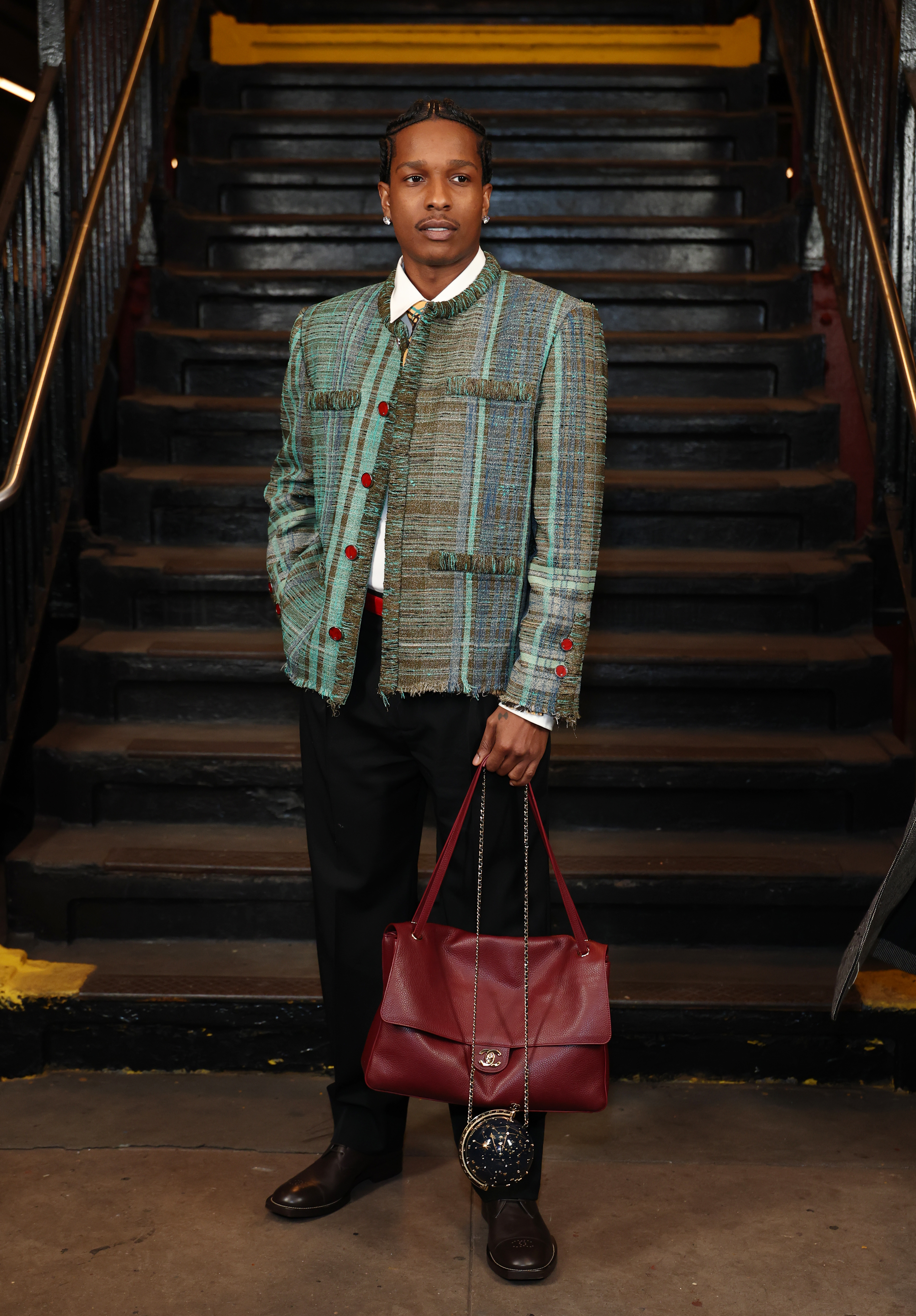 A$AP Rocky attended the Metiers d'Art Spring 2026 show with a burgundy Chanel flap bag