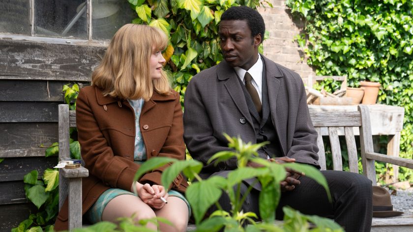 Rosalind and Cyril talk on a bench in a garden