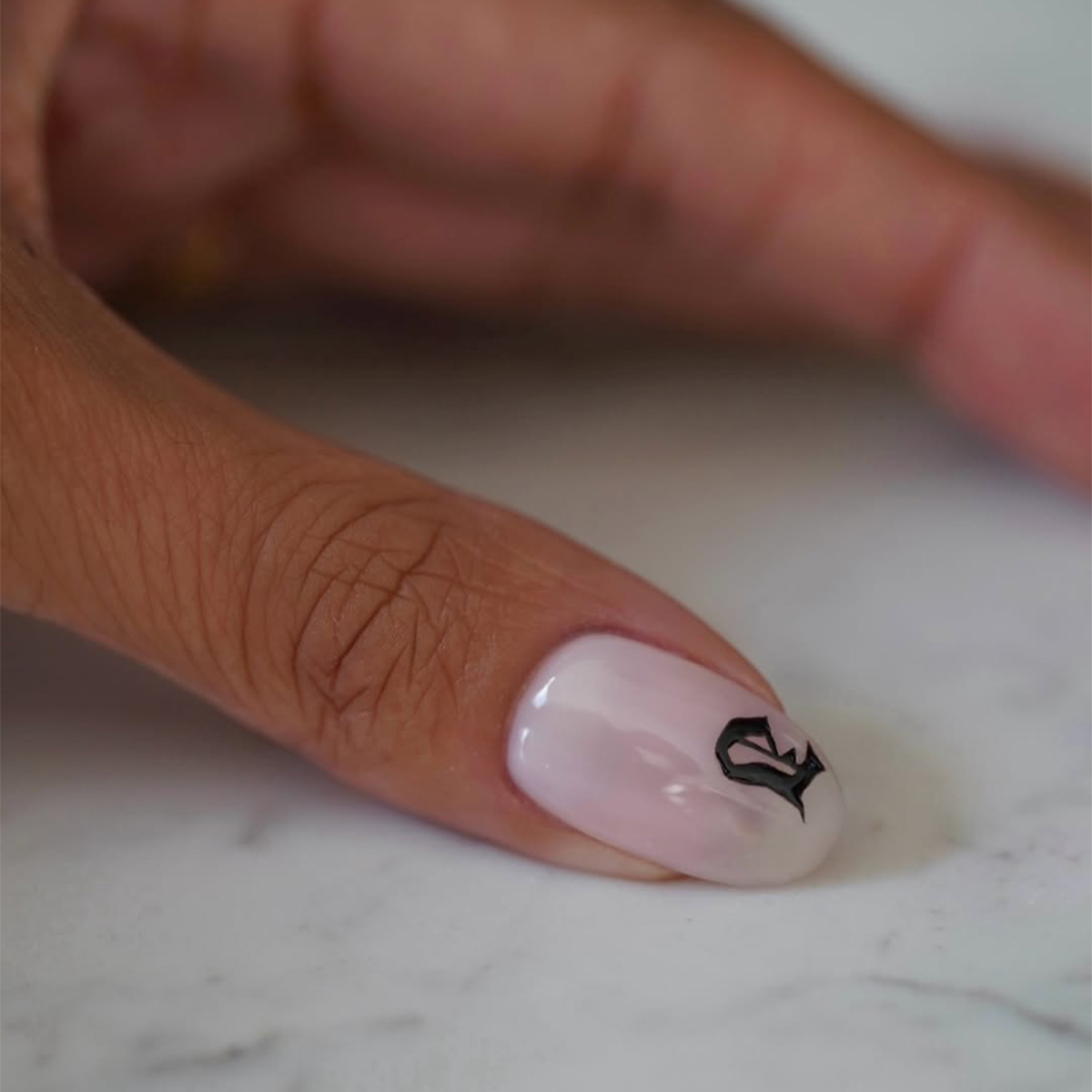 A manicure with an initial detail by Iram Shelton
