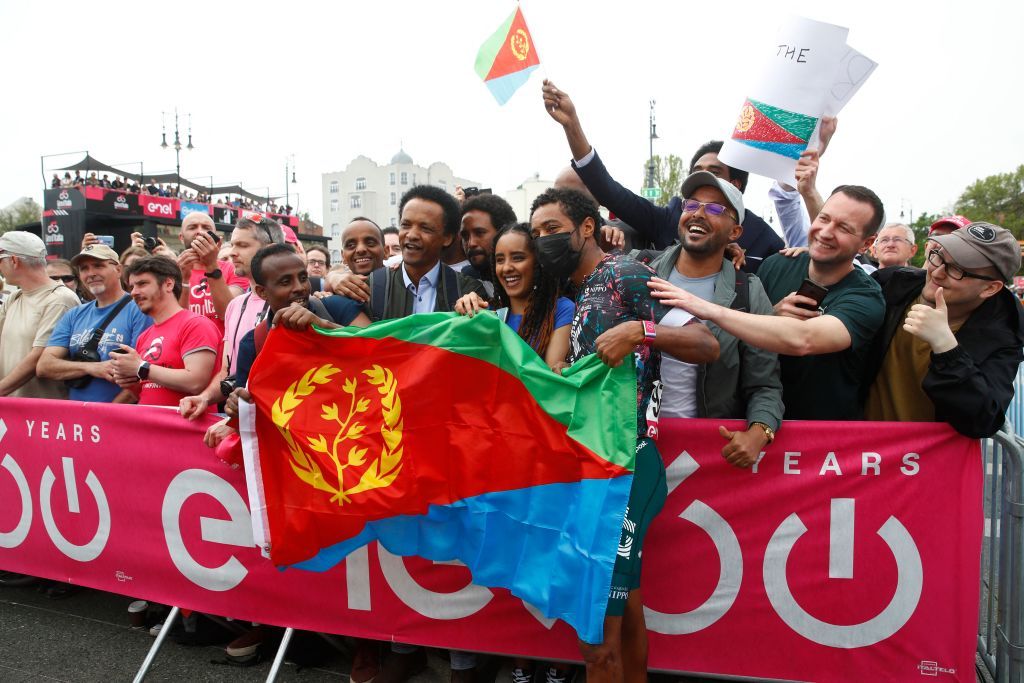 Team Education Firsts Eritrean rider Merhawi Kudus CR poses with fans holkding the flag of Eritrea prior to the start of the first stage of the Giro dItalia 2022 cycling race 195 kilometers between Budapest and Visegrad Hungary on May 6 2022 Photo by Luca Bettini AFP Photo by LUCA BETTINIAFP via Getty Images