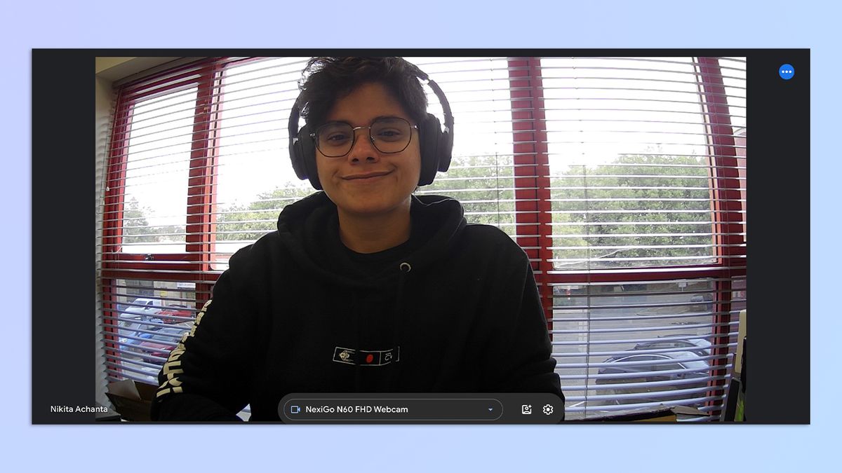 A still of a woman with short hair and headphones on, taken on a MacBook Air M2