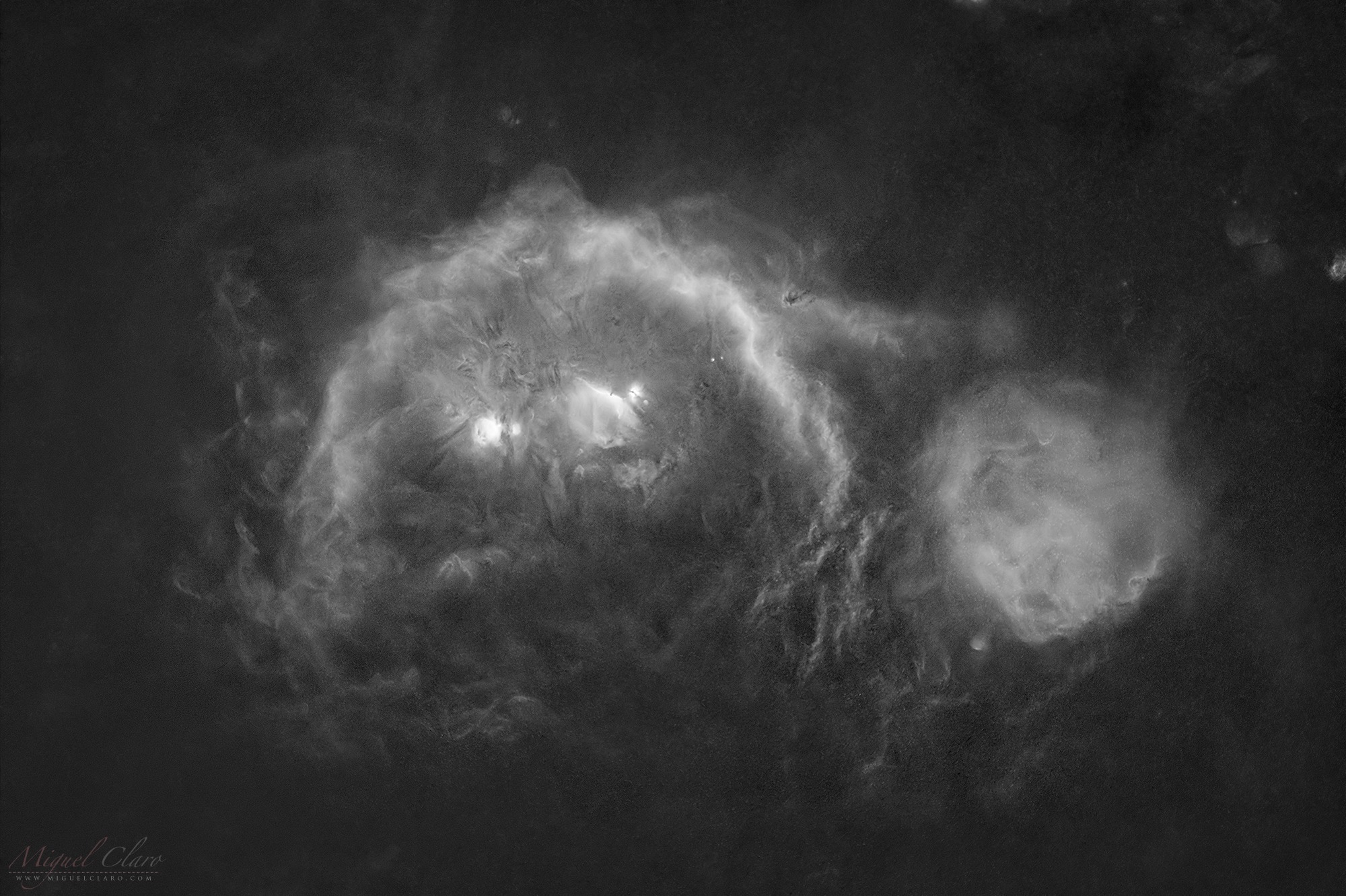 a red cloud of gas seen in front of thousands of background stars