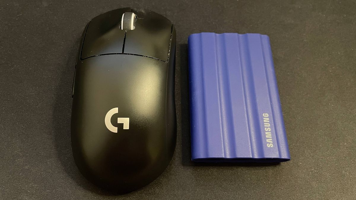 Samsung T7 Shield external SSD next to gaming mouse for size comparison
