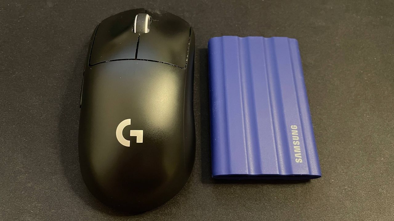 Samsung T7 Shield external SSD next to gaming mouse for size comparison
