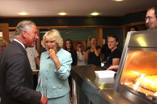 ABERAERON, UNITED KINGDOM - JULY 11: Prince Charles, Prince Wales and Camilla, Duchess of Cornwall visit an award-winning fish and chip shop on July 11, 2012 in Aberaeron, Wales. (Photo by Anwar Hussein/Getty Images)