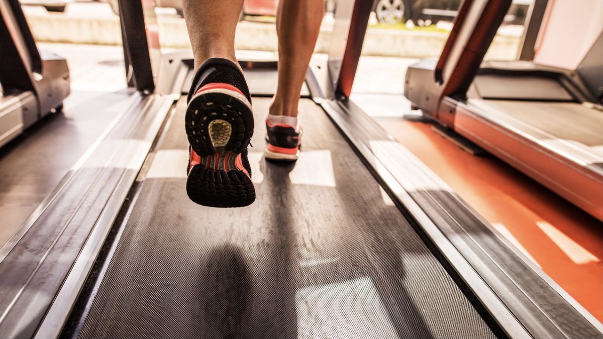 Person&#039;s feet running on a treadmill