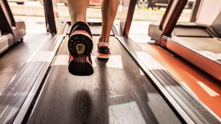 Person's feet running on a treadmill
