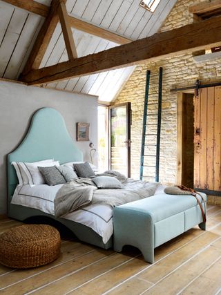 Rustic bedroom with upholstered blue bed