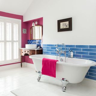 bathroom with white wall and white flooring with white bathtub and white washbasin