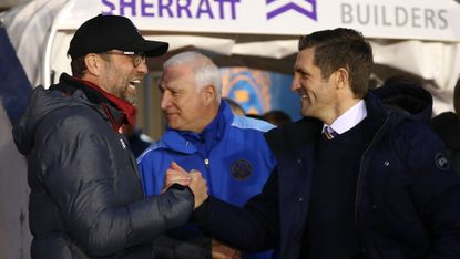 Liverpool manager Jurgen Klopp shakes hands with Shrewsbury Town boss Sam Ricketts