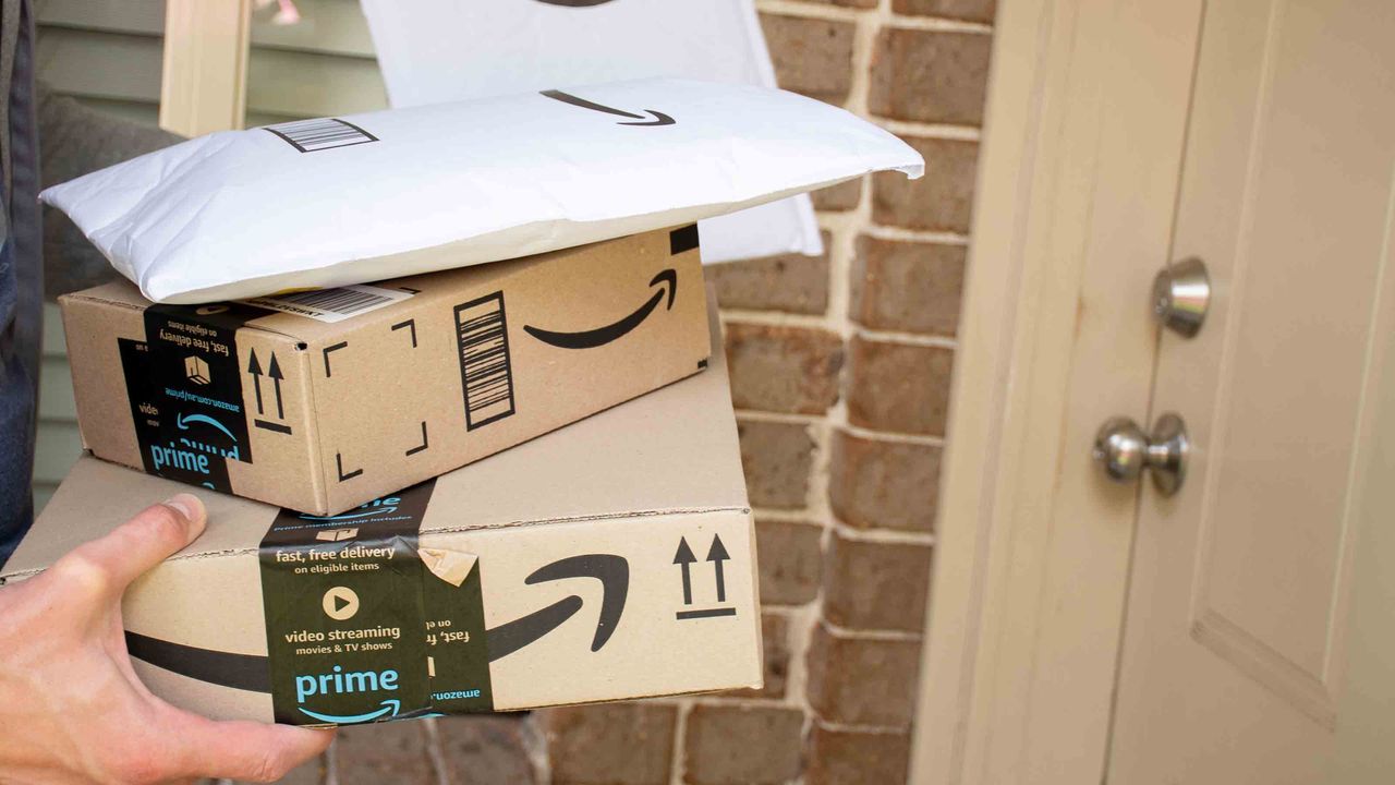 Amazon prime boxes and envelopes delivered to a front door of residential building