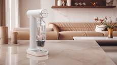 the white smeg soda maker sat in a beige kitchen