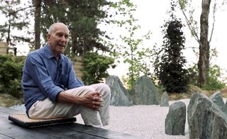 Leonard Koren sitting in the Wabisabiculture garden